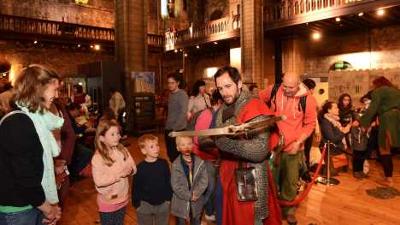 Man dressed in chainmail demonstrating crossbow